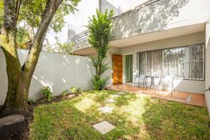 a home with a patio and a tree at II St Tropez Sandton Luxury Suites in Johannesburg