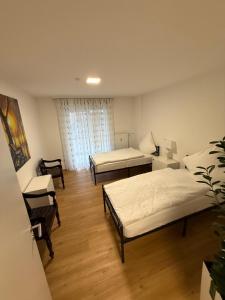 a small room with two beds and a couch at Ferienwohnung-Montagewohnung 1 in Paderborn +4 photos