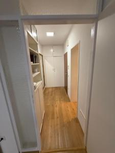 a hallway of an apartment with white walls and wooden floors at Ferienwohnung-Montagewohnung 1 in Paderborn