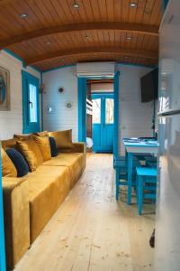 a living room with a couch and a table at Roulottes et son kota grill sauna in Bucilly