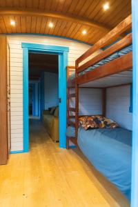 a bedroom with two bunk beds and a hallway at Roulottes et son kota grill sauna in Bucilly +75 photos