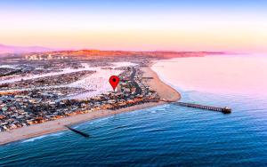 an aerial view of a beach with a red marker at 2026 Award Winner, Luxe 2BR, steps to sand & pier, with fire pit, AC and parking in Newport Beach