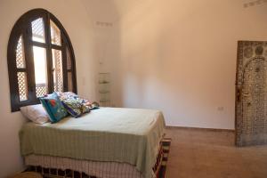 a bedroom with a bed and a window at Laziza in Luxor