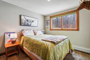 a bedroom with a bed and a window at Sunrise Timberline K8 in Killington +19 photos