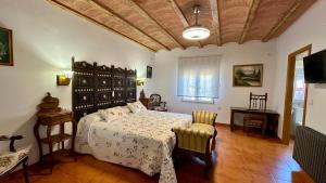 a bedroom with a bed and a table and chairs at Finca El Rosario in Casas de los Pinos +37 photos