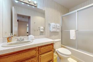 a bathroom with a sink and a toilet and a shower at Golfer's Villa in Bigfork +18 photos