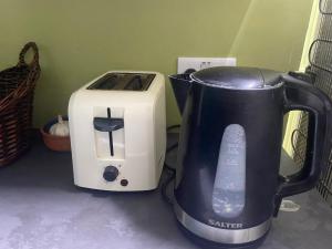 a coffee maker and a toaster sitting on a counter at The Windsor Room in Windsor