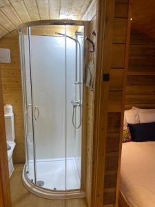 a bathroom with a shower in a room with a bed at Crabmill glamping bewdley in Bewdley +103 photos