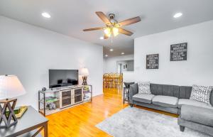 a living room with a couch and a flat screen tv at Ocala Retreat with Pool, Grill and Yard - Pets Welcome in Ocala