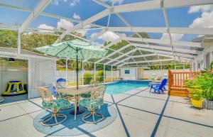 a patio with a table and chairs and a pool at Ocala Retreat with Pool, Grill and Yard - Pets Welcome in Ocala