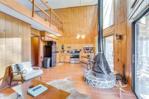 a living room with a fireplace and a kitchen at Private Deck and Fire Pit Secluded Cabin in Murphy in Salem