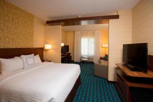 a hotel room with a bed and a flat screen tv at Fairfield Inn & Suites by Marriott Durango in Durango
