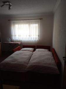 a bedroom with a large bed in front of a window at studio SM IK 3 in Tomislavgrad