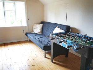 a living room with a blue couch and a table with a chessboard at 6 person holiday home in HALLABRO-By Traum in Hallabro