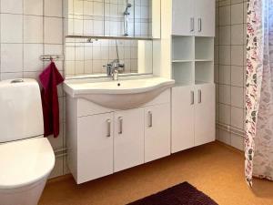 a bathroom with a sink and a toilet at 4 star holiday home in FäRJESTADEN in Färjestaden