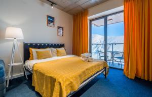a bedroom with a bed with a teddy bear on it at New Gudauri Geoflats in Gudauri