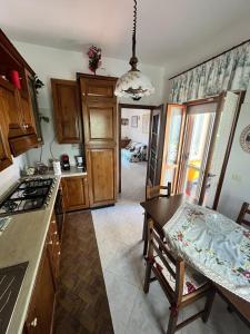 a kitchen with a table and a dining room at Ciotti Rosella affittacamere in Acquaviva Picena