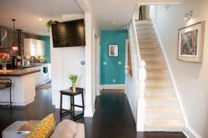 a living room with a staircase and a kitchen at KingstonStays Spacious Historic Downtown Stableman's House Loft in Kingston +24 photos