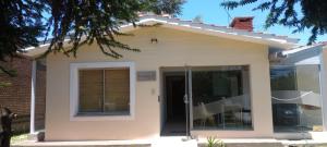 a small house with a front door at Hostel El Chinchero in Merlo