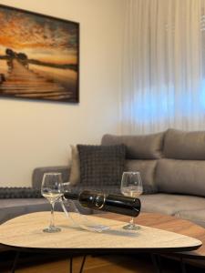 two glasses of wine on a table in a living room at Luxury apartment Gabi 1 in Slavonski Brod