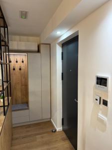 a hallway with a black door in a room at Luxury apartment Gabi 1 in Slavonski Brod