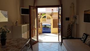 a room with a door leading to a house at Casa Maestrale in Villasimius +1 photo