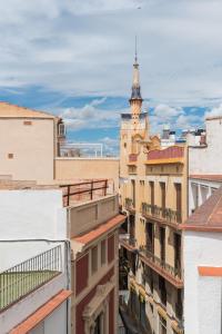 a view from the roof of a building with a clock tower at Apartamentos Mayor by HABAMA in Sitges