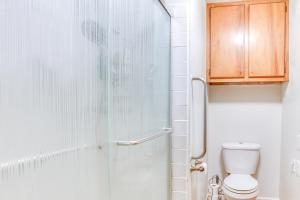 a bathroom with a shower and a toilet at Sunny Hilo Home with Game Room Walk to Golf Course! in Hilo +17 photos