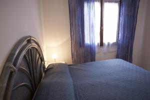A bed or beds in a room at Appartamenti Bilo Sofi