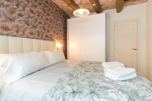 a bedroom with a bed with towels on it at Apartamentos Mayor by HABAMA in Sitges
