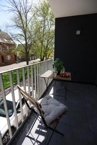 a chair sitting on a balcony with a table at Apartment "London" in Erftstadt - 3 Zimmer & 63qm - nahe Köln, Messe, Phantasialand & Bonn - Familienurlaub oder Business Trip in Erftstadt