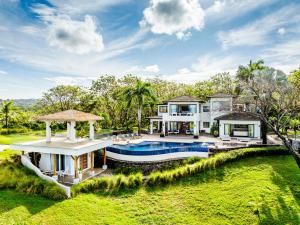 an aerial view of a house with a swimming pool at The Point Your Private Oceanfront Resort in Tamarindo
