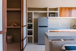 a kitchen with a refrigerator and a counter top at Condominios Evamar San Carlos in Rancho El Pozo