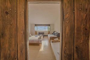 a room with a bedroom with a bed and a couch at Zeljana in Metajna