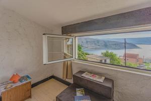 a living room with a large window and a couch at Zeljana in Metajna
