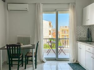 eine Küche mit Tisch und Blick auf einen Balkon in der Unterkunft Martheo Studios 2 in Mytilini