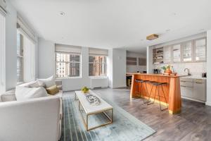 a living room and kitchen with a couch and a table at 17John in New York
