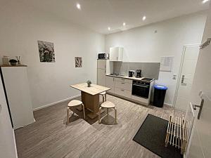 a small kitchen with a table and a counter top at Vilstal Apartments in Reisbach