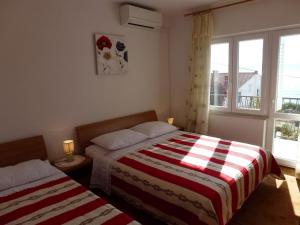 Posteľ alebo postele v izbe v ubytovaní Apartments Sunset