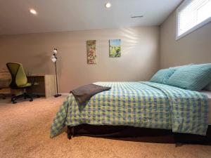 a bedroom with a bed and a desk and a chair at Welcome to Shibly's Retreat in Edmonton
