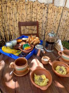 a table with a tray of breakfast food on it at Casapueblo in Cachí +52 photos