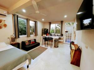 a bedroom with a bed and a kitchen with a sink at Mangal Suites in Brisas de Zicatela