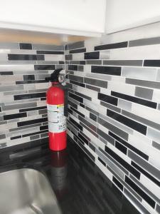 a brick wall with a fire extinguisher in a bathroom at Baldwin, NY 1 Bedroom Apartment Queen Size Bed in Baldwin