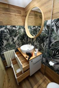 a bathroom with a sink and a mirror at 5 mins to the beach, cozy home in Rapallo