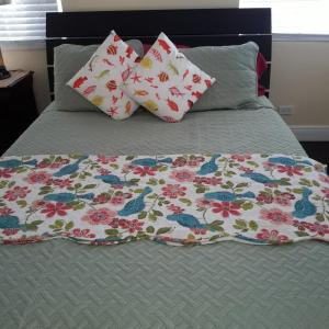 a bed with two pillows and a blanket on it at Island Vibes Point of View- Near Beach & Airport in Nassau +64 photos