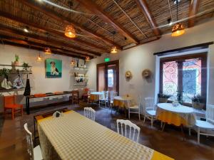 a restaurant with tables and chairs in a room at Hostal Suite Le Fabrique in Cuenca