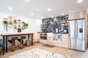 a kitchen with a refrigerator and a table at NEW Romantic LakeView Studio Beach Pool Modern in McCall