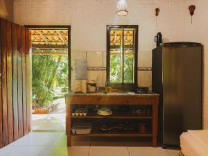 a kitchen with a stainless steel refrigerator in a room at Residencial Casa da Praia Itacaré in Itacaré +29 photos
