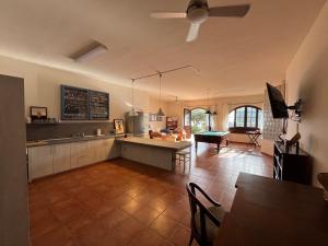 a kitchen and living room with a table and a couch at Finca Los Tomillos in Candelaria