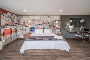 a bedroom with a bed and a wall with boats at Boutique Hotel King, Queen & Kitchen Suites Easy Drive to Downtown in Prescott